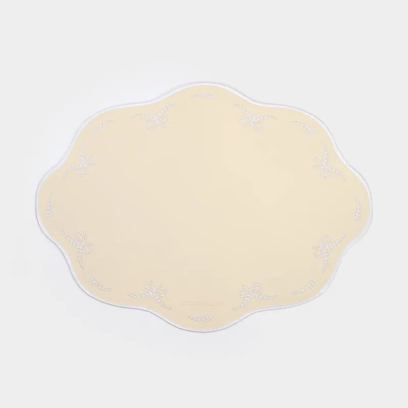 Placemat, 30x40 cm, PVC / polyester, shaped, light yellow, Bows, Rock embroidery